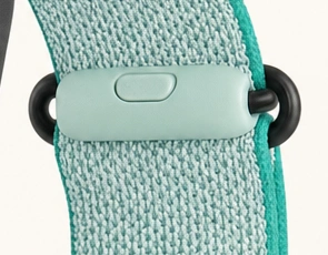 Close-up of the mint safety clasp at the fabric strap closure.